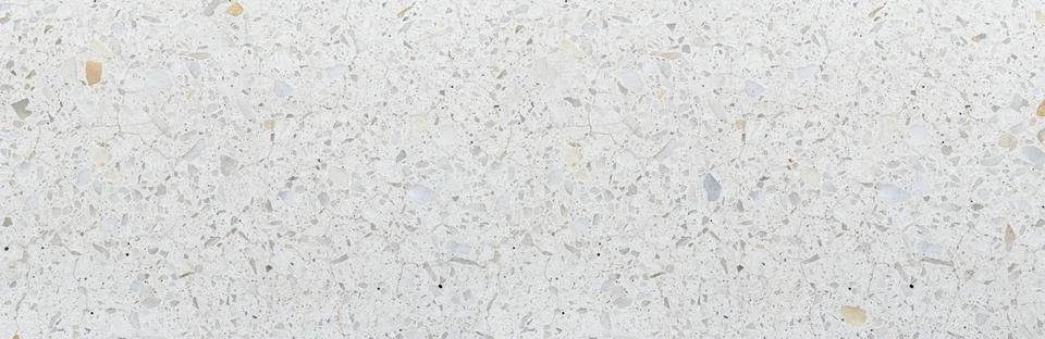 White terrazzo pattern creating textured stone surface Stockfoto's