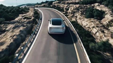 White Tesla Model 3 Driving on Winding Mountain Road Video stock 334444388