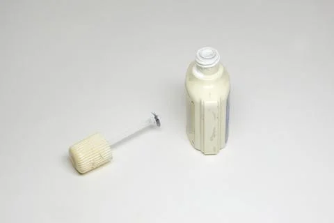 White text correction fluid. old open plastic bottle. thread of neck in dry.. Stock Photos