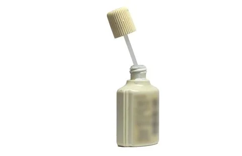 White text correction fluid in plastic ribbed bottle. applicator with long .. Stock Photos