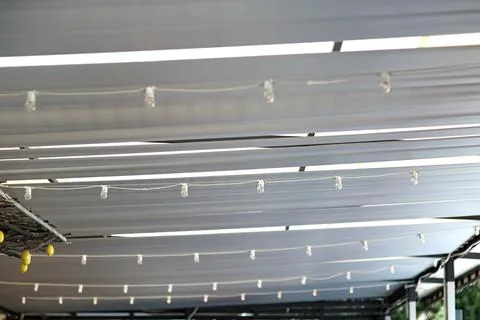White textile ceiling of the sun shade canopy on the backyard terrace. Stock Photos
