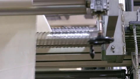 White Textile Fabric Passing Through Industrial Machine Rollers Stock Footage 328643538