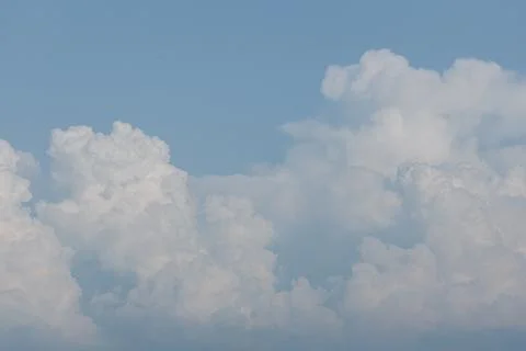 White textured clouds on the background of the blue sky. Feeling of freedom Stock Photos