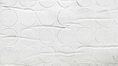 White textured paper background with embossed repetitive circle pattern and s Foto stock