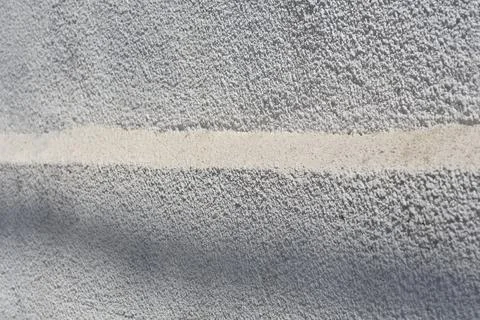 White textured plaster wall with smooth horizontal stripe Stock Photos