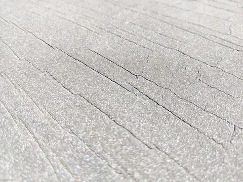 White textured surface with linear cracks in macro style natural daylight Stock Photos