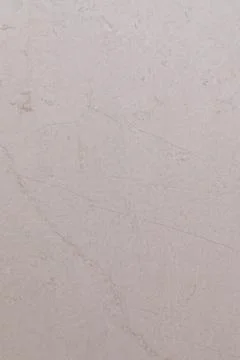 White textured wall with subtle variations in color and pattern creates a serene Stock Photos