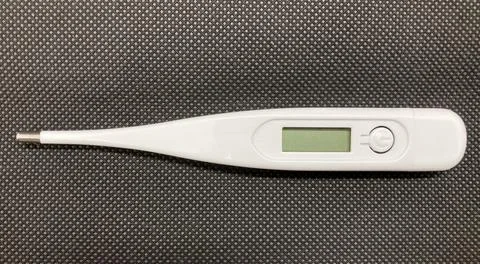 White thermometer with black background Stock Photos