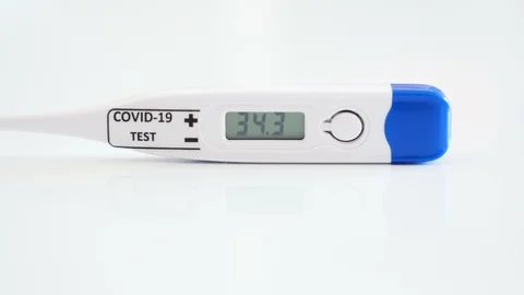 A white thermometer to check for coronavirus or Covid-19 Stock Footage 129463169
