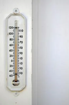 White thermometer outside with the temperature at 60 degrees Stock Photos