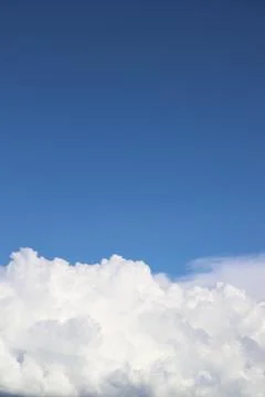 White thick clouds and blue sky background Stock Photos