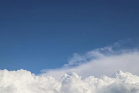 White thick clouds and blue sky background Stock Photos