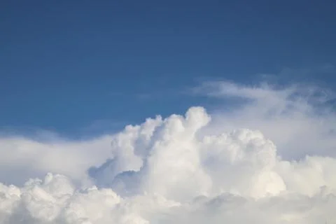 White thick clouds and blue sky background Stock Photos