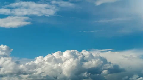 White thick clouds fast moving on bright blue sky at sunny day Stock Footage 160589375