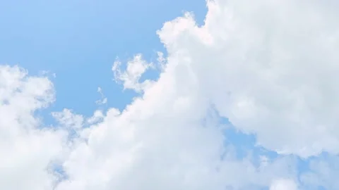 White thick clouds float in the soft blue sky. Stock Footage 197430211
