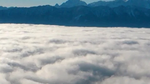 White thick fog as if an approaching storm of various shapes and mountains on Stock Footage 256237941