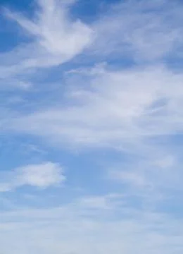 White thin clouds over a blue sunny sky Stock Photos