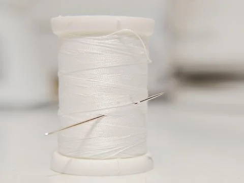 White thread on spool Stock-Fotos