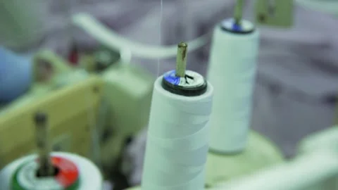 White thread spool with sewing machine in factory Video stock 210165651