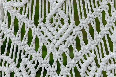 White threads craft hand made knitted pattern folk foreground with blurred .. Foto stock