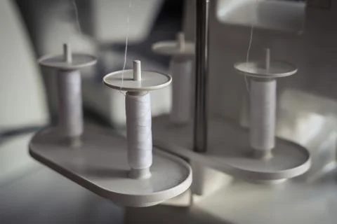 White threads on an overlock sewing machine Stock Photos