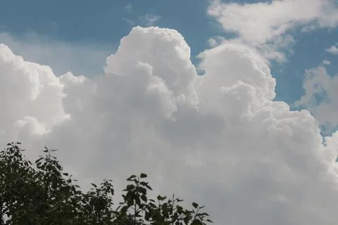 White thunderclouds in blue sky. summer cumulus clouds before rain. Beautiful Stock Photos