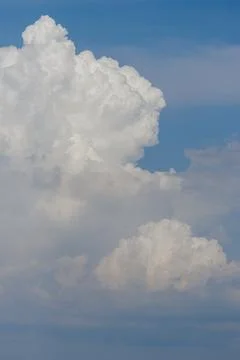 White thunderclouds in blue sky. summer cumulus clouds before rain. Beautiful Stock Photos