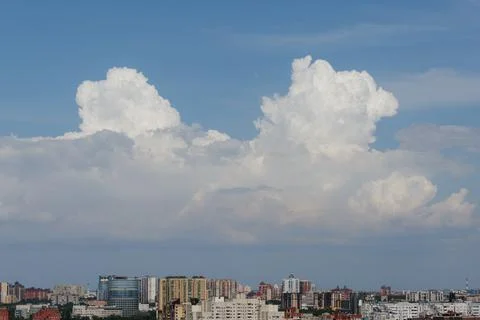 White thunderclouds in blue sky. summer cumulus clouds before rain. Beautiful Stock Photos