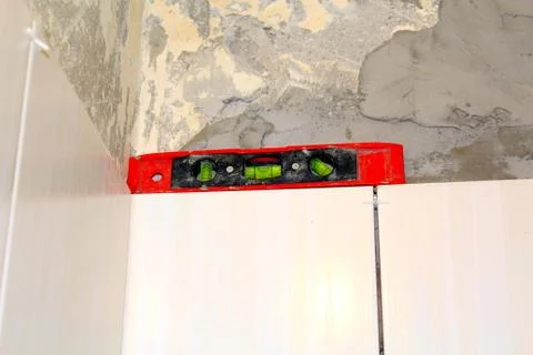 White tile wall background and construction tools Foto stock