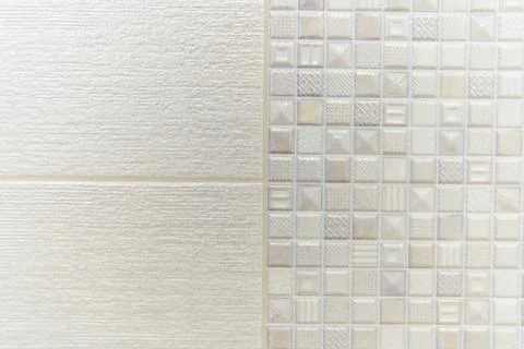 A white tile wall with a pattern of squares and triangles 写真素材