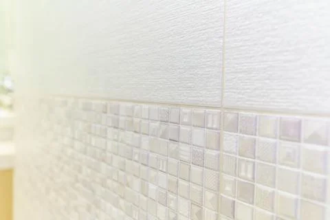 A white tile wall with a pattern of squares and triangles 写真素材