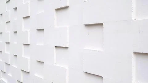 White tile wall with a textured 3D geometric pattern Stock Photos