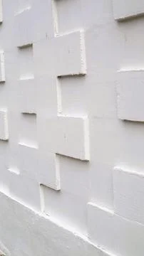 White tile wall with a textured 3D geometric pattern Stock Photos