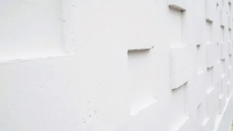 White tile wall with a textured 3D geometric pattern 스톡 사진