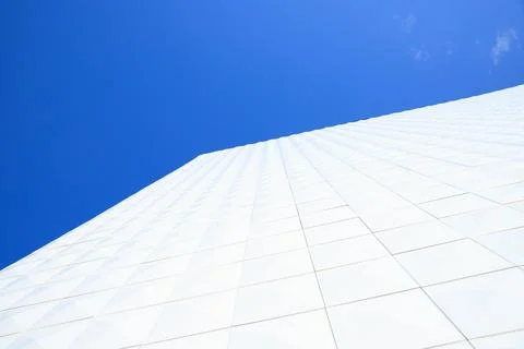 White tiling. View looking up at corner of white generic building facade on.. Stock Photos