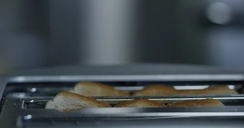 White toast rises up from toaster than quickly goes back down - side profile Stock Footage 101268619