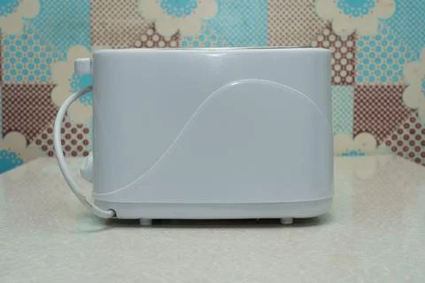 White toaster on a kitchen counter with a patterned background Stock Photos