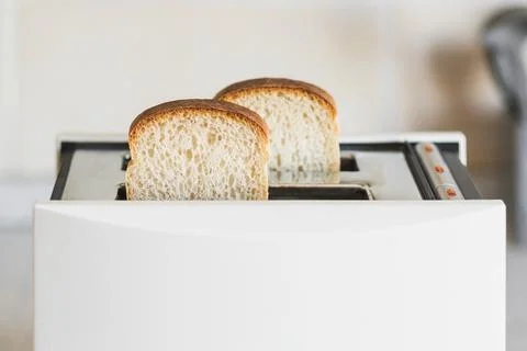 White toaster with white bread in a bright kitchen, selective soft focus, high Stock Photos