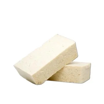 White tofu cube isolated on plain white background side view Stock Photos