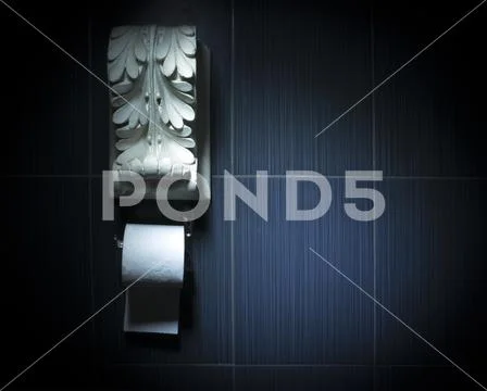 White toilet paper roll with white antique plaster decoration above Stock Photos