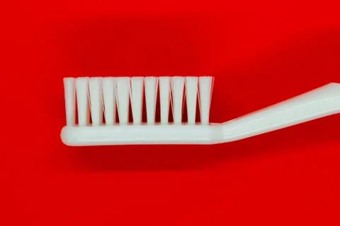 White toothbrush on red background Stock Photos