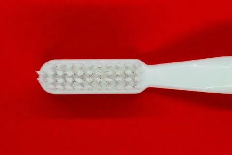 White toothbrush on red background Stock Photos