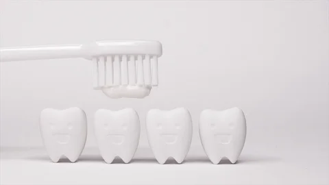 White Toothbrush with Toothpaste on Tooth model in happy emotion Video stock 103355106