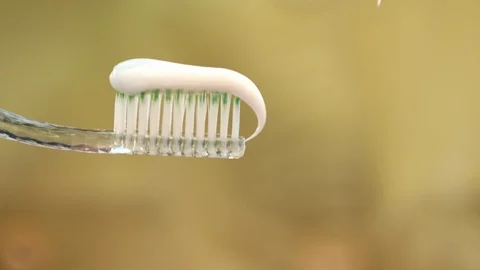 White toothpaste squeezing on toothbrush. Woman hand holding toothbrush Stock Footage 97212087