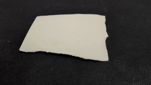 White torn paper  on black background Stock Footage 309238042