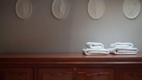 White towels are on the bedside table. A game of shadows. Stock Footage 180517731