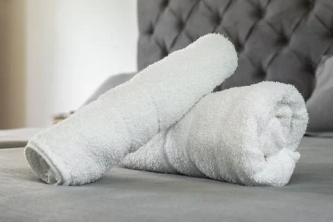 White towels on the bed Stock Photos