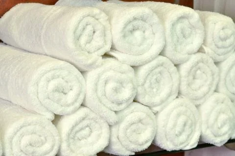 White towels texture background. White clean towels on bathroom shelf in spa Stock Photos