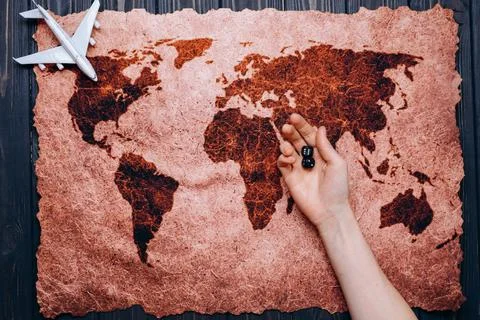 The white toy plane on the world map and dice Stock Photos