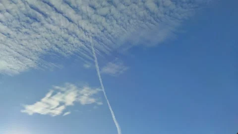 A white trail in the blue sky after an airplane Stock Footage 330309704